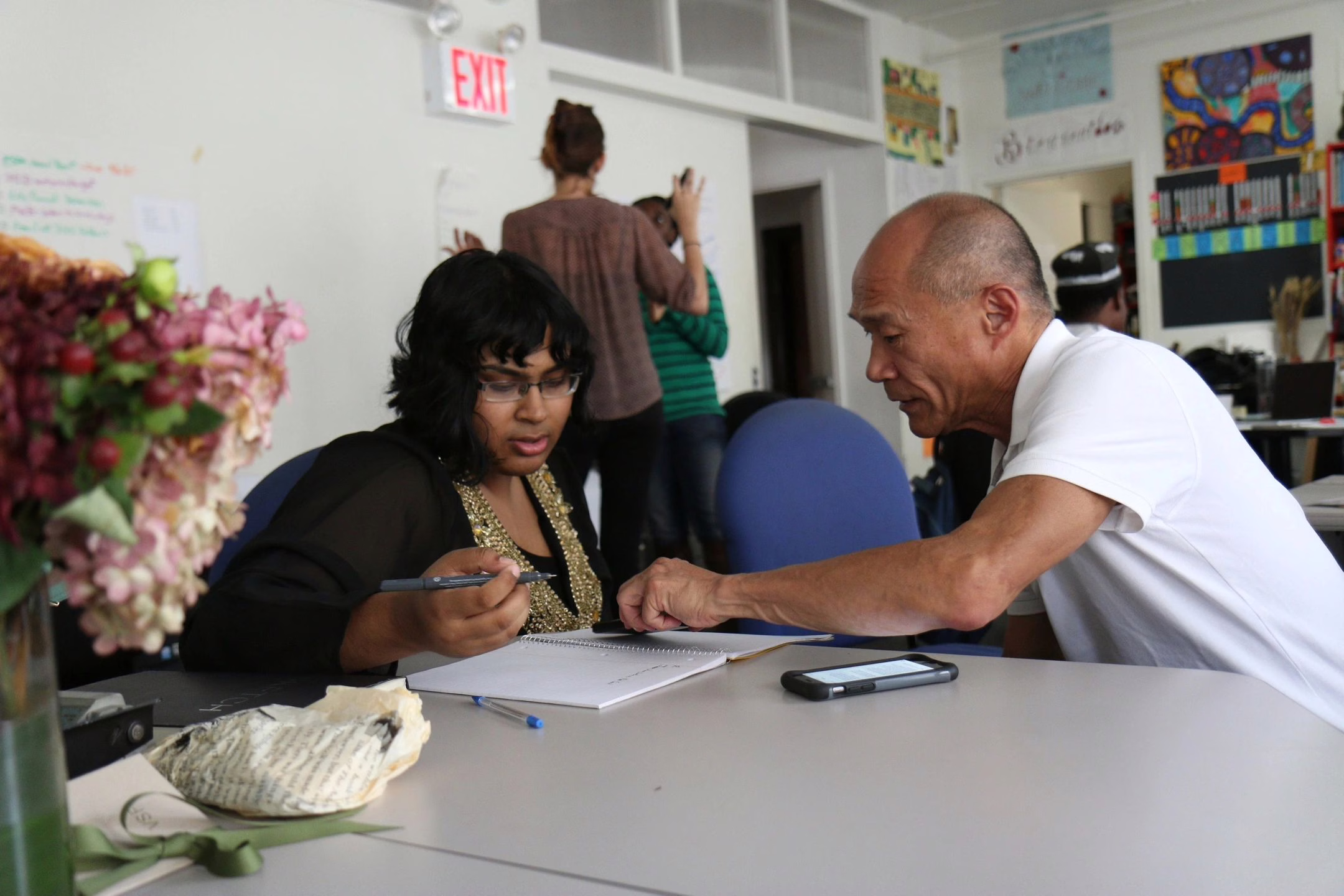 A man assists a woman in a church multi-purpose room